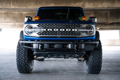 Front license plate relocation bracket places plate to the side of the bumper. by DV8 Offroad