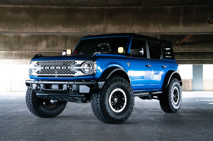 Front license plate relocation bracket places plate to the side of the bumper. by DV8 Offroad