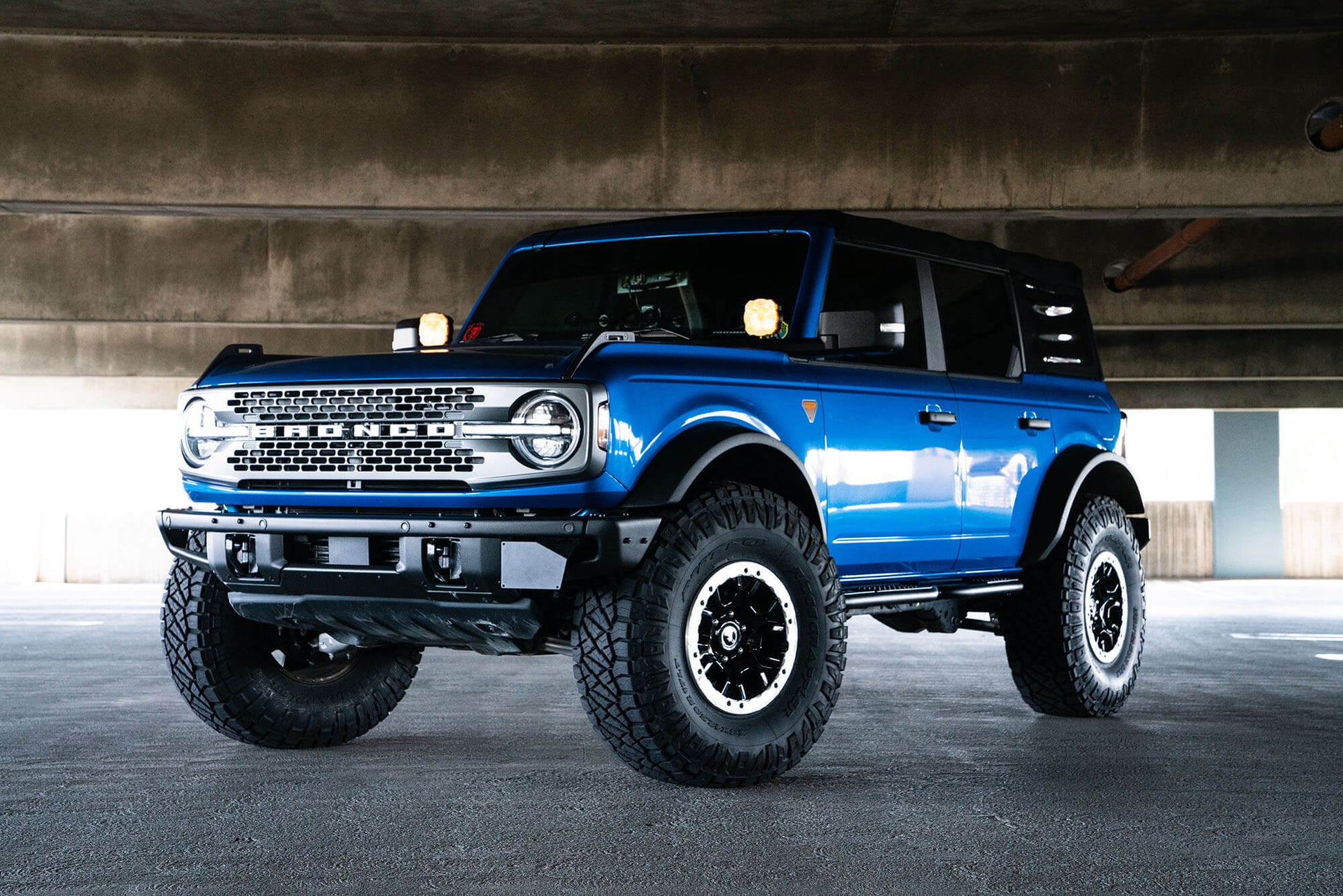 Front license plate relocation bracket places plate to the side of the bumper. by DV8 Offroad