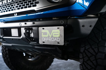 Front license plate relocation bracket places plate to the side of the bumper. by DV8 Offroad