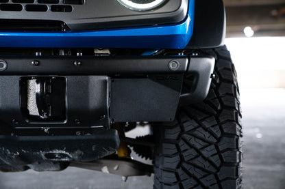 Front license plate relocation bracket places plate to the side of the bumper. by DV8 Offroad