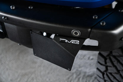 Front license plate relocation bracket places plate to the side of the bumper. by DV8 Offroad